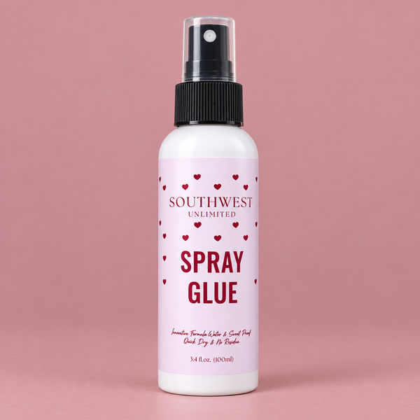 Spray glue bottle with white label, black spray nozzle, pink background, and red heart accents, labeled "Southwest Unlimited Spray Glue."